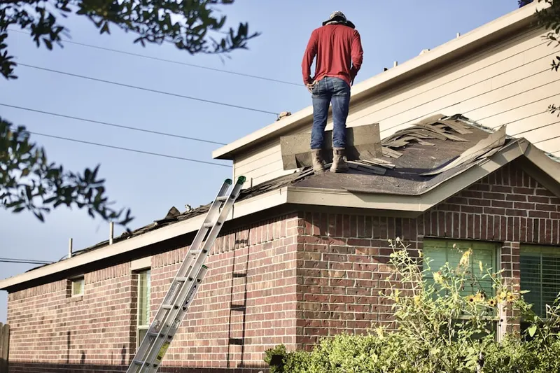 Professional roofer working on a residential roof in Avery Creek